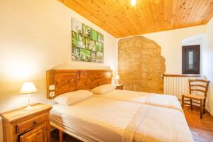 a bedroom with a large bed with a wooden headboard at Sant Grau I in Navés +36 photos