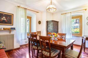 a dining room with a wooden table and chairs at Casa Ai Laresi 1 in Peio +13 photos