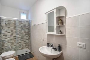 a bathroom with a sink and a toilet and a mirror at Cà du Mandaìn in Pairola +19 photos