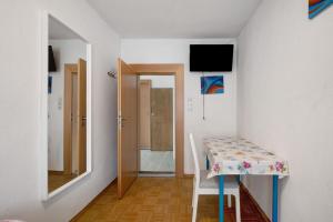 a small room with a table and a mirror at Haus Steinheim in Dillingen an der Donau