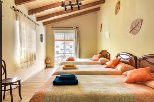 a bedroom with four beds in a room at Tío Salvador in Bolbaite