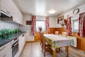 a kitchen with a table and chairs and a table and a kitchen with a table at Haus Steinheim in Dillingen an der Donau
