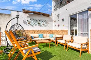 a patio with chairs and a swing at Tío Salvador in Bolbaite