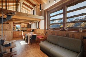 a living room with a couch and a table at Casa Promindoz in Valtournenche