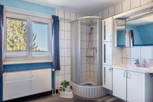 a bathroom with a shower and a sink at Blackforest Ferienwohnung in Sankt Georgen im Schwarzwald +25 photos