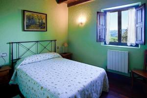 a bedroom with a bed and a window at Fuenternilla in Carranza