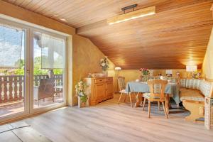a dining room with a table and a balcony at Auenwald in Roding