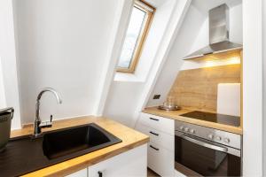 a kitchen with a sink and a stove at Nurdachhaus Sauerland in Kirchhundem