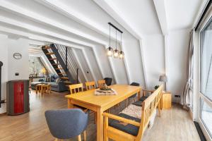 a dining room with a wooden table and chairs at Nurdachhaus Sauerland in Kirchhundem