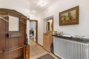 a room with a wooden door and a radiator at Auf Der Stadtmauer in Schmallenberg +21 photos