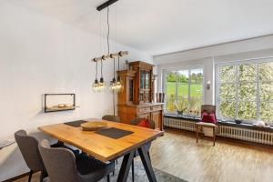 a dining room with a wooden table and chairs at Auf Der Stadtmauer in Schmallenberg