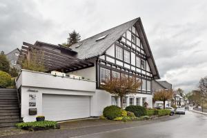 a black and white house with a garage at Auf Der Stadtmauer in Schmallenberg