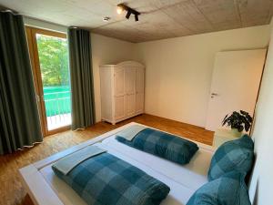 a bedroom with a large bed and a large window at Ferienwohnung Grüner Ausblick in Elzach