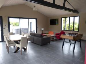 a living room with a couch and a table with a chessboard at Hâvre de Paix Perros in Perros-Guirec