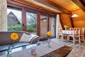 a living room with a couch and a table at Gemütliches Nurdachhaus Bodensee in Immenstaad am Bodensee