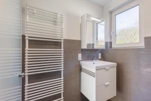 a bathroom with a sink and a mirror at Ferienanlage am Seerand in Joachimsthal +83 photos