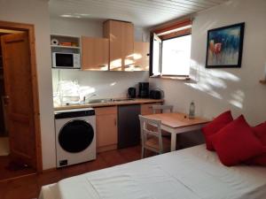 a kitchen with a bed and a table in a room at Ferienwohnung Dörflich in Meinerzhagen +7 photos