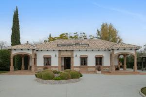 a large white building with bushes in front of it at Villa los mellizos in Arriate