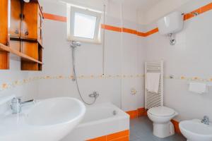 a bathroom with a sink and a toilet at Casa vacanze Elettra in centro in Otranto +23 photos