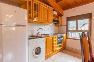 a kitchen with a refrigerator and a washing machine at Casa Batlle Ginebro in Les Iglésies +13 photos