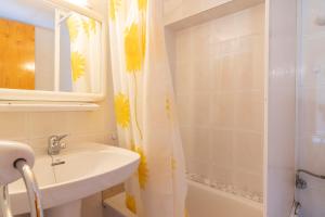 a bathroom with a sink and a shower curtain at Casa Batlle Ginebro in Les Iglésies