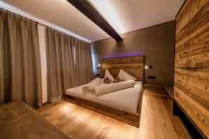 a bedroom with a bed and a large window at Sonnleiten Sonnenadler 1 in Collepietra +34 photos
