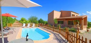 a villa with a swimming pool in front of a house at Can Olivaret in Campos