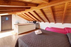 a bedroom with a bed in a room with wooden ceilings at Casabianca - The best for bikers in Finale Ligure
