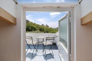 a balcony with chairs and a table on a balcony at Casabianca - The best for bikers in Finale Ligure +18 photos
