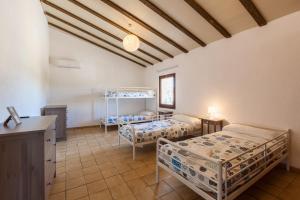 a bedroom with two beds in a room with a counter at Masía Can Trabal in Olerdola +36 photos