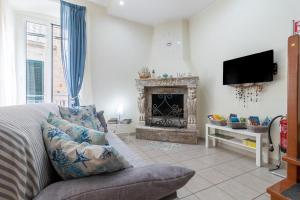 a living room with a couch and a fireplace at Acquamarina in Giovinazzo