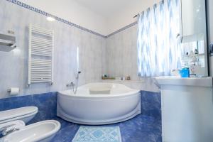 a bathroom with a tub and a toilet and a sink at Acquamarina in Giovinazzo +22 photos