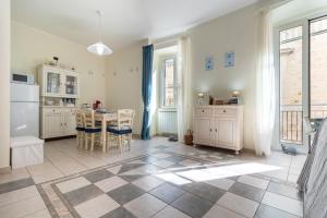 a kitchen with white cabinets and a table with chairs at Acquamarina in Giovinazzo