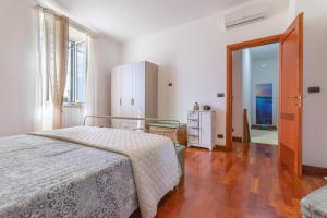 a bedroom with a bed and a dresser in it at Acquamarina in Giovinazzo