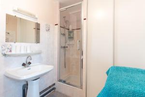 a bathroom with a sink and a shower at Gite Bellevue Accous in Accous +18 photos