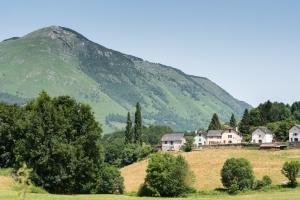 a house on a hill in front of a mountain at Gite Bellevue Accous in Accous
