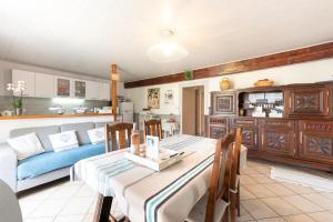 a kitchen and living room with a table and chairs at Gite Bellevue Accous in Accous