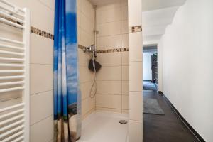 a walk in shower in a bathroom with white walls at Peenecamp Neukalen, Campingplatz in Neukalen +40 photos
