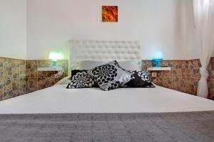 a bedroom with a white bed with pillows on it at Casa Anpi in Costa de Antigua
