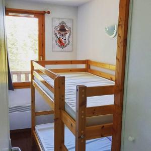 a bunk bed in a room with a window at Appartement Le Maevan in Vassivière +7 photos