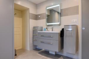a bathroom with a sink and a mirror at Gîte Le Rempart in Guebwiller +19 photos