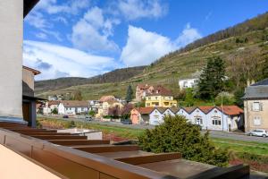 a view of a town with a mountain at Gîte Le Rempart in Guebwiller