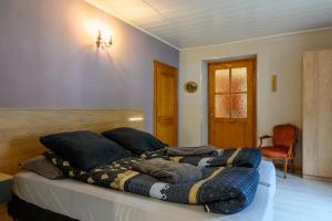 a bedroom with a bed with a blanket on it at Gîte Le Rempart in Guebwiller