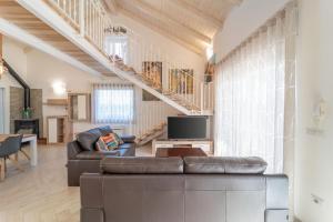 a living room with a couch and a tv at Capriccio Mediterraneo in Sassari