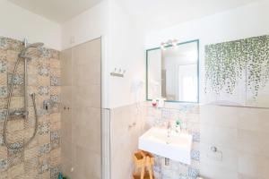 a bathroom with a shower and a sink and a mirror at Capriccio Mediterraneo in Sassari +22 photos