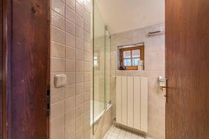 a bathroom with a shower with a glass door at Haus Löweneck in Bayrischzell +24 photos