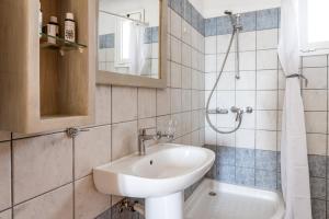 a bathroom with a sink and a shower at Anemologio 302 Tinos in Agios Ioannis +16 photos