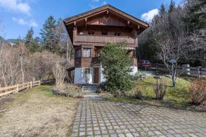 a house with a stone path in front of it at Haus Löweneck in Bayrischzell
