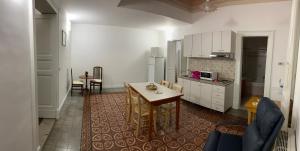 a kitchen with a table and a dining room at Crispi Accomodation B&B in Catania