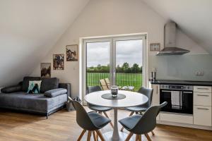 a kitchen and living room with a table and chairs at Fewo Parkside S5 - 8Min Legoland in Günzburg